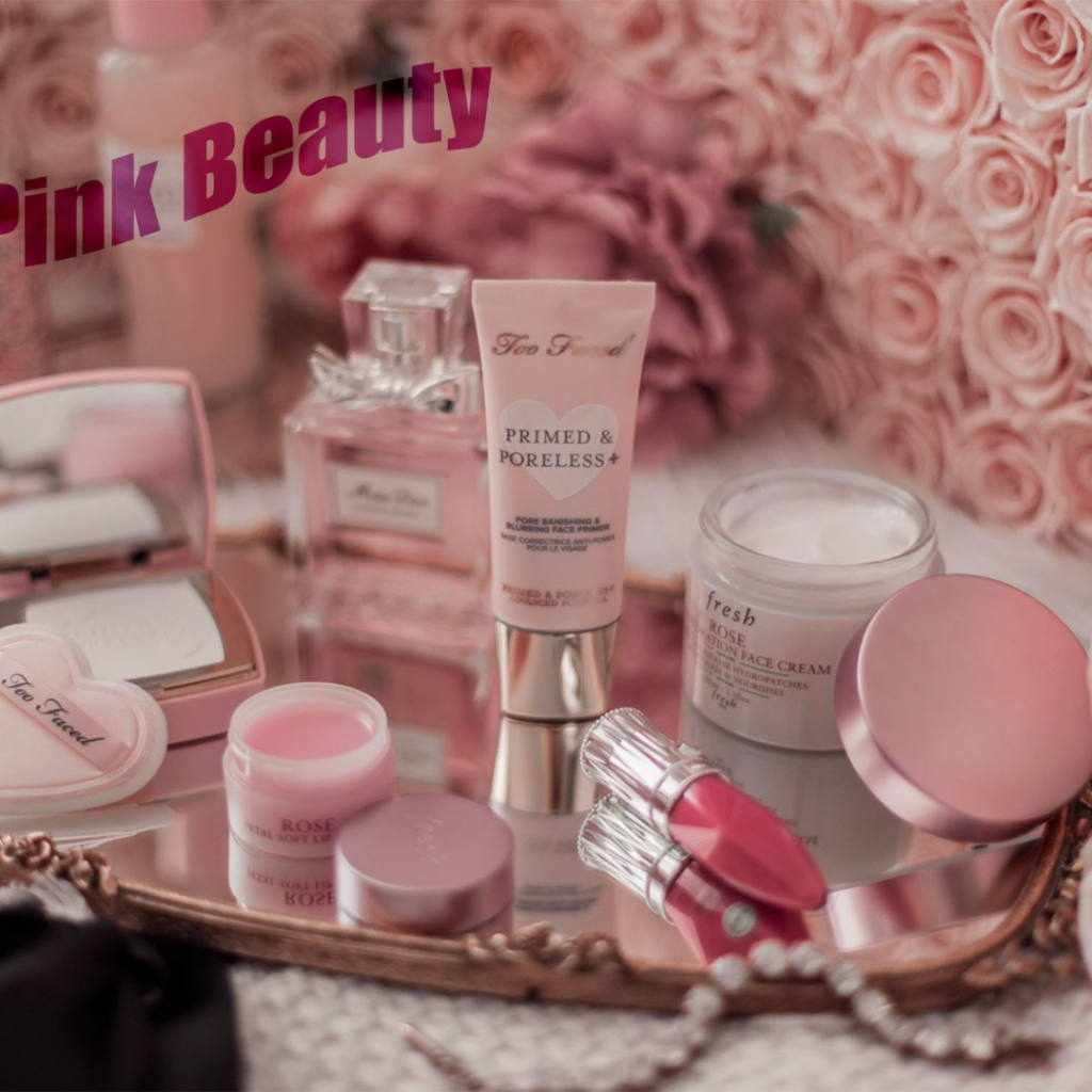 Pink-themed beauty products including face cream, lip balm, primer, and perfume on a floral background – IZA Beauty Home Services