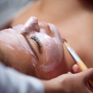 IZA Beauty professional performing a relaxing skin treatment at home
